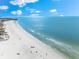 Aerial view of a beautiful beach with clear water and white sand at 6312 Midnight Pass Rd # 702S, Sarasota, FL 34242