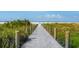 Wooden boardwalk leads to beautiful Siesta Beach at 6312 Midnight Pass Rd # 702S, Sarasota, FL 34242
