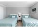 Guest bedroom with two twin beds and white dresser at 6312 Midnight Pass Rd # 702S, Sarasota, FL 34242