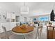 Casual dining area with wood table and white chairs at 6312 Midnight Pass Rd # 702S, Sarasota, FL 34242