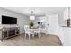 Charming dining area with white table and chairs at 6312 Midnight Pass Rd # 702S, Sarasota, FL 34242