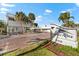 Building entrance with signage and landscaping at 6312 Midnight Pass Rd # 702S, Sarasota, FL 34242