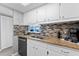 Bright kitchen boasts granite countertops and ocean views at 6312 Midnight Pass Rd # 702S, Sarasota, FL 34242