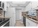 Modern kitchen features stainless steel appliances and light wood flooring at 6312 Midnight Pass Rd # 702S, Sarasota, FL 34242