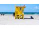 Yellow lifeguard stand on a sandy beach at 6312 Midnight Pass Rd # 702S, Sarasota, FL 34242