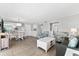 Bright living room with ocean view, comfy seating, and hardwood floors at 6312 Midnight Pass Rd # 702S, Sarasota, FL 34242