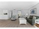 Living room with comfy seating and partial kitchen view at 6312 Midnight Pass Rd # 702S, Sarasota, FL 34242