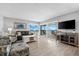 Bright living room with ocean view, comfy seating, and access to balcony at 6312 Midnight Pass Rd # 702S, Sarasota, FL 34242