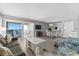 Spacious living area with ocean view, comfy seating, and hardwood floors at 6312 Midnight Pass Rd # 702S, Sarasota, FL 34242