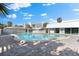 Community pool with patio and surrounding buildings at 6312 Midnight Pass Rd # 702S, Sarasota, FL 34242