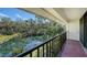 Serene balcony overlooking a picturesque pond and lush greenery at 6450 Wild Oak Bay Blvd # 238, Bradenton, FL 34210