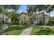 Condo building with palm trees and brick walkways at 6450 Wild Oak Bay Blvd # 238, Bradenton, FL 34210