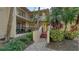 Condo entrance with stairs and tropical landscaping at 6450 Wild Oak Bay Blvd # 238, Bradenton, FL 34210