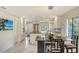 Modern kitchen with white cabinets, breakfast bar, and marble floors at 6450 Wild Oak Bay Blvd # 238, Bradenton, FL 34210
