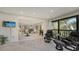 Open living room with marble floors and access to a balcony at 6450 Wild Oak Bay Blvd # 238, Bradenton, FL 34210