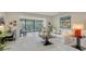 Bright living room with a sofa, armchair, and access to balcony at 6450 Wild Oak Bay Blvd # 238, Bradenton, FL 34210