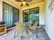 Outdoor patio with seating area and glass doors at 6680 Willowshire Way, Bradenton, FL 34212