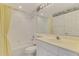 This bathroom features a shower and tub, and a vanity sink with a large mirror at 6750 Fairway Gardens Dr # 6750, Bradenton, FL 34203