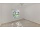 Bright bedroom features neutral carpet, ceiling fan, and a window at 6750 Fairway Gardens Dr # 6750, Bradenton, FL 34203
