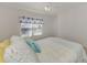 Bright bedroom with neutral carpet features a ceiling fan and a comfortable bed with pillows at 6750 Fairway Gardens Dr # 6750, Bradenton, FL 34203