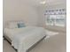 Bright bedroom features neutral carpet, ceiling fan, and a comfortable bed with accent pillows at 6750 Fairway Gardens Dr # 6750, Bradenton, FL 34203