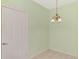 The dining area features tile flooring, light green walls, and a charming chandelier at 6750 Fairway Gardens Dr # 6750, Bradenton, FL 34203