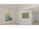 Bright dining room with an elegant chandelier, a window view, and an opening to the kitchen at 6750 Fairway Gardens Dr # 6750, Bradenton, FL 34203