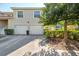 Exterior view featuring attached garages, well-maintained landscaping, and a private entrance at 6750 Fairway Gardens Dr # 6750, Bradenton, FL 34203