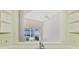 View from sink to bright living space with fan, and natural light streaming in at 6750 Fairway Gardens Dr # 6750, Bradenton, FL 34203