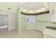 Bright eat-in kitchen offering white appliances, light green walls, and an open view to living area at 6750 Fairway Gardens Dr # 6750, Bradenton, FL 34203