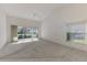 Bright living space featuring high ceilings, neutral walls, tile and carpet floors, and natural light at 6750 Fairway Gardens Dr # 6750, Bradenton, FL 34203