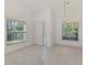 Bright living space with vaulted ceilings, tile floors, and abundant natural light from large windows at 6750 Fairway Gardens Dr # 6750, Bradenton, FL 34203