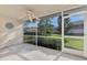 A screened patio with a ceiling fan offers a relaxing outdoor space with views of the green yard at 6750 Fairway Gardens Dr # 6750, Bradenton, FL 34203