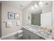 Modern bathroom with gray vanity, granite countertop, and walk-in shower at 72 N School Ave, Sarasota, FL 34237