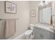 Stylish bathroom with gray vanity, granite countertop, and toilet at 72 N School Ave, Sarasota, FL 34237