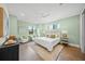 Bright bedroom with a king-size bed and light green walls at 72 N School Ave, Sarasota, FL 34237