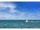 Small motorboat cruising on calm, clear ocean waters at 72 N School Ave, Sarasota, FL 34237
