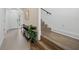 Modern entryway with stairs, console table and plants at 72 N School Ave, Sarasota, FL 34237