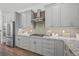 Modern kitchen with gray cabinets, granite counters, and stainless steel appliances at 72 N School Ave, Sarasota, FL 34237
