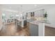Open concept kitchen with island, stainless steel appliances, and hardwood floors at 72 N School Ave, Sarasota, FL 34237