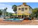 Quaint outdoor cafe with yellow umbrellas and a decorative fountain in a charming town square at 72 N School Ave, Sarasota, FL 34237