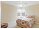 Bedroom with two windows, ceiling fan, and patterned bedding at 7244 Orchid Island Pl, Bradenton, FL 34202