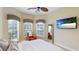 Guest bedroom with queen-size bed and large TV at 7244 Orchid Island Pl, Bradenton, FL 34202