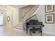 Elegant entryway with grand staircase and Yamaha grand piano at 7244 Orchid Island Pl, Bradenton, FL 34202