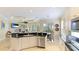 Open kitchen with island, breakfast bar, and stainless steel appliances at 7244 Orchid Island Pl, Bradenton, FL 34202