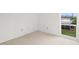 Empty bedroom with window view and neutral wall colors at 7304 W Country Club N Dr # 213, Sarasota, FL 34243