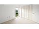 Bright bedroom featuring a window overlooking a green space and built-in closet at 7304 W Country Club N Dr # 213, Sarasota, FL 34243