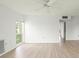 Bright bedroom featuring wood-look floors and large window at 7304 W Country Club N Dr # 213, Sarasota, FL 34243
