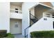 Condo building exterior showcasing stairs and landscaping at 7304 W Country Club N Dr # 213, Sarasota, FL 34243
