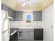 Efficient kitchen with gray cabinets and appliances at 7304 W Country Club N Dr # 213, Sarasota, FL 34243